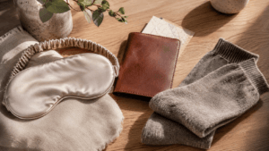 A beautiful flatlay of lifestyle gifts, including a sleep mask and leather holder.