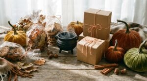 A beautifully styled autumn flat-lay of Halloween wrapping materials on a wood background.
